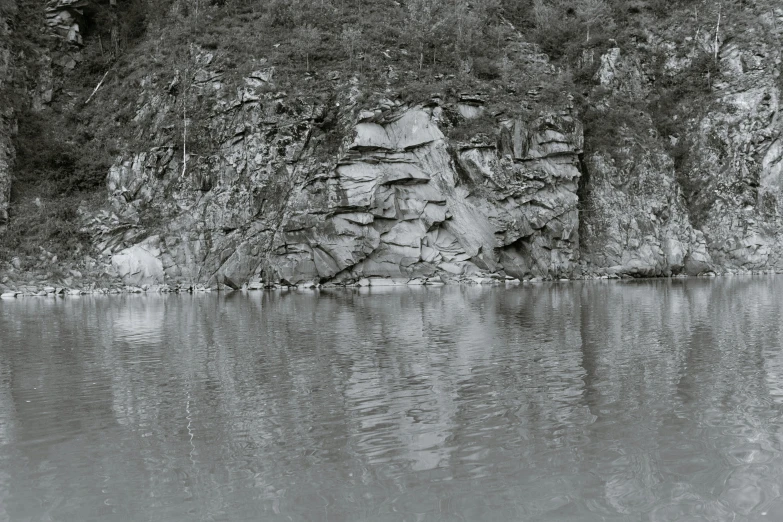 a black and white po of the water and rocks