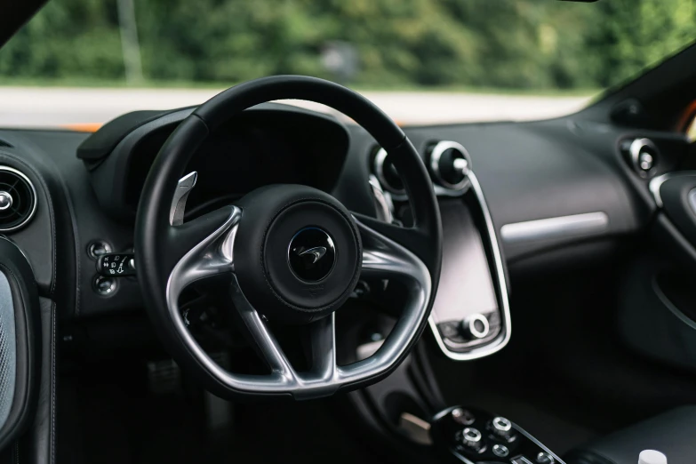 the interior of a black sports car with an automatic clock