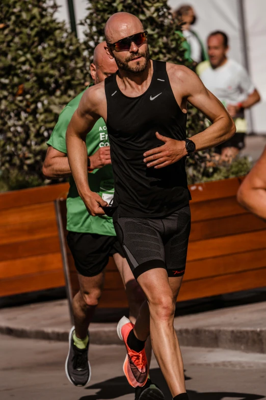 a man with his face shaved running along side another man