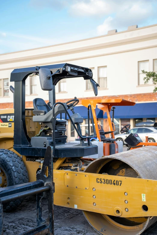 the front end of a dump truck sits in the dirt