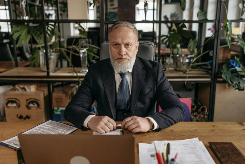 a man is at a desk with a book