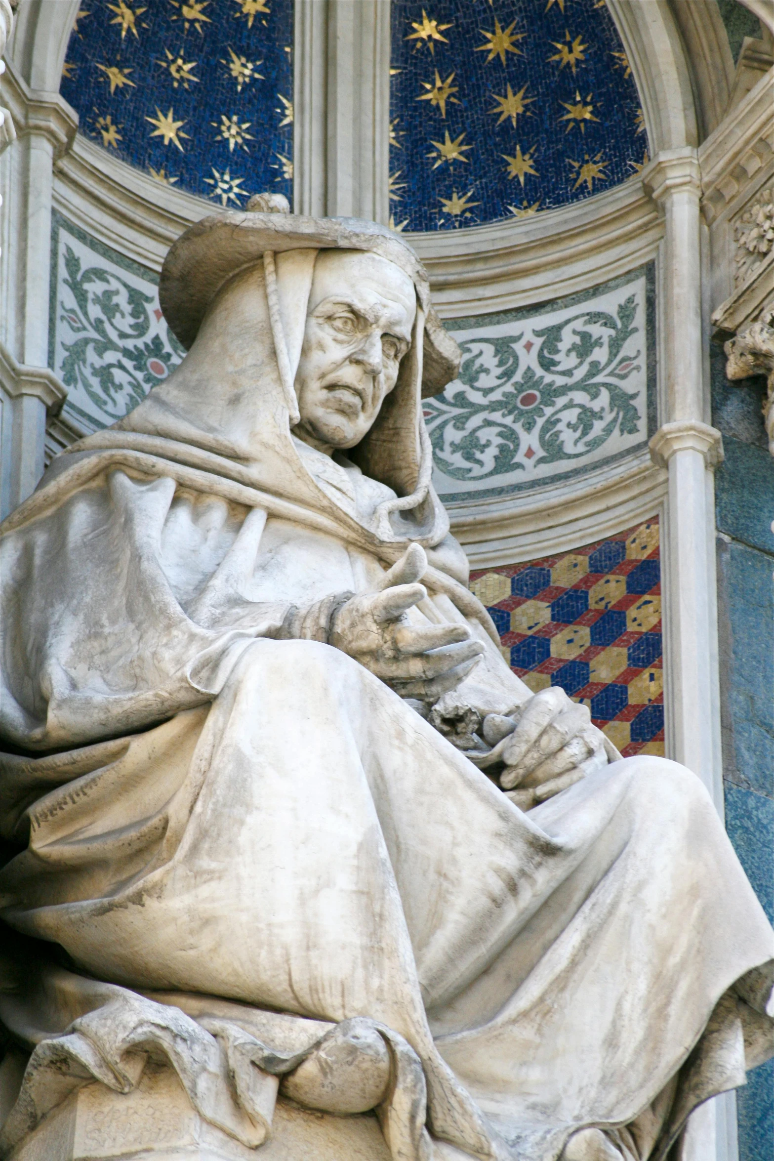 a statue of an old man holding a book