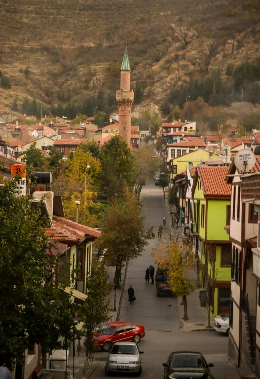 a street in a town with several buildings and cars