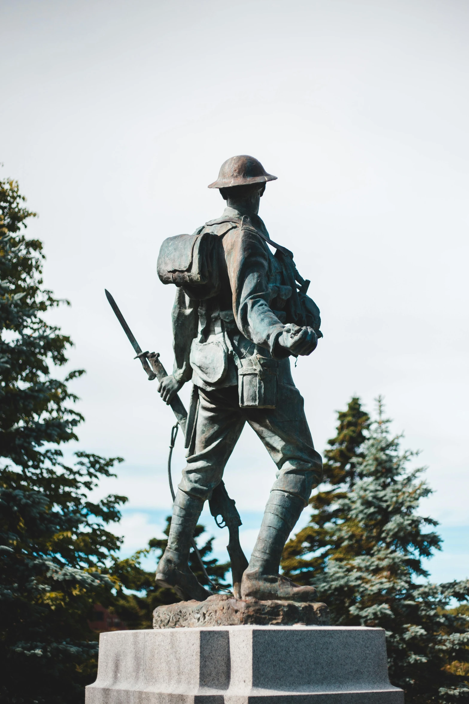 a statue of a soldier standing with a rifle in his hand