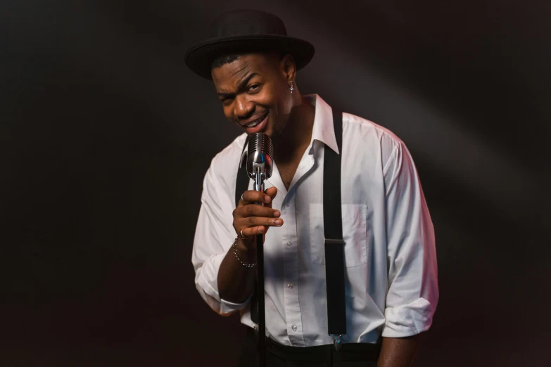 a man wearing suspenders, a white shirt and a black hat