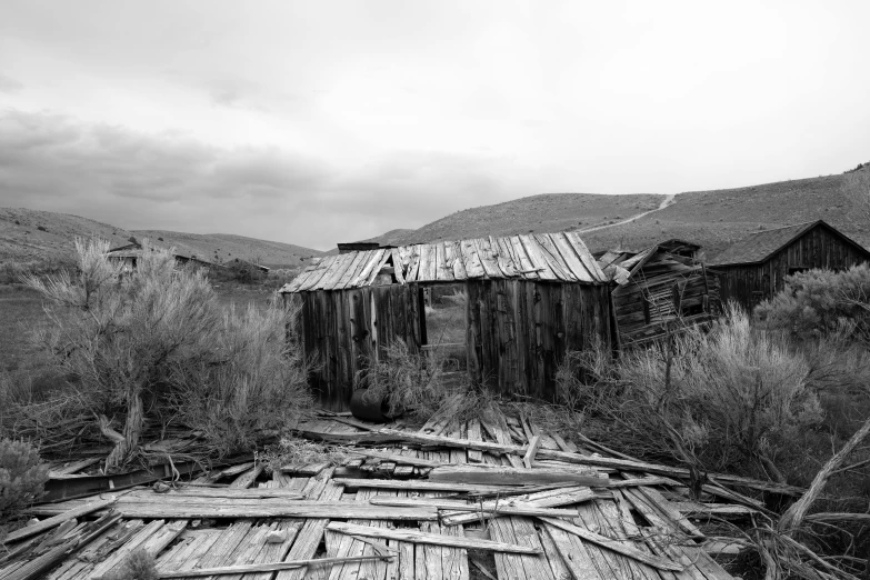 an old wood shack with the roof broken in