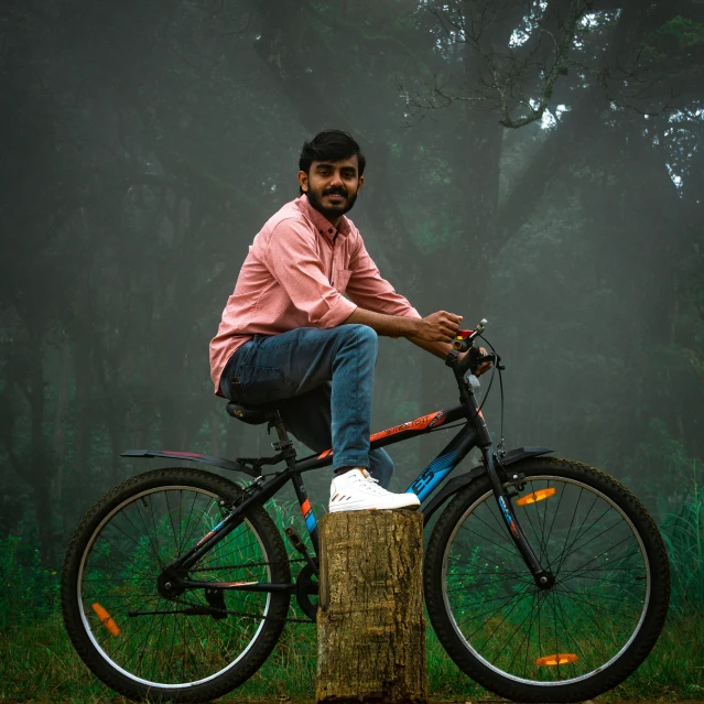 a man sitting on top of a wooden trunk on top of a bike