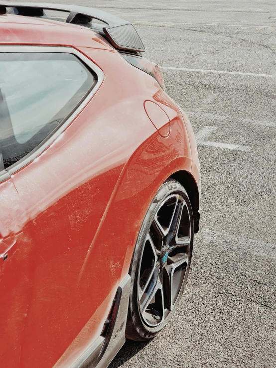 a red sports car in the parking lot