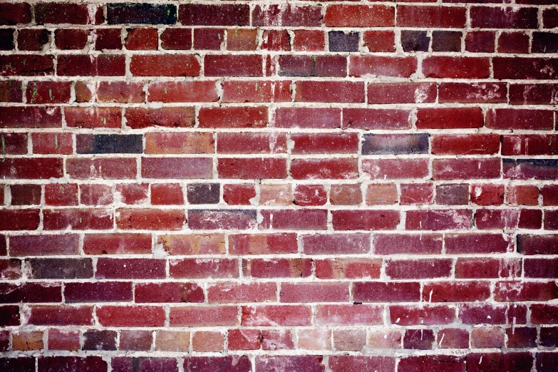 the brick wall is red with lots of black spots