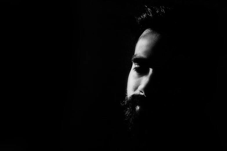 a bearded man with a serious look on his face