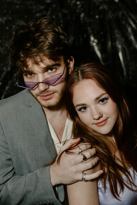 a close up of a couple wearing sunglasses