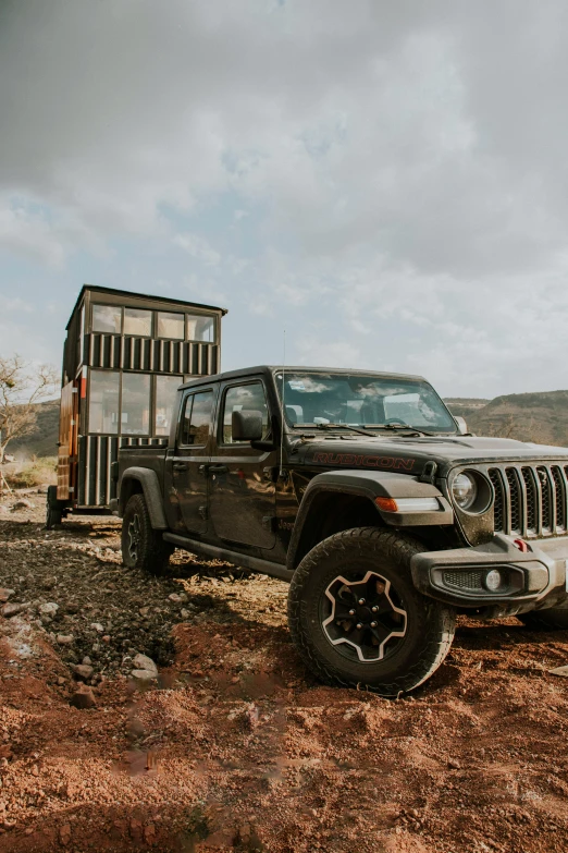 a jeep that is parked outside by some rocks