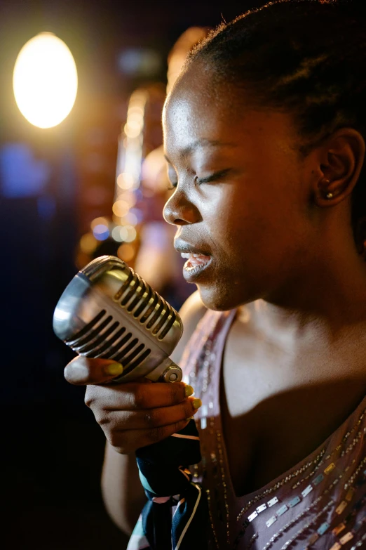 a young woman holding a microphone up to her mouth