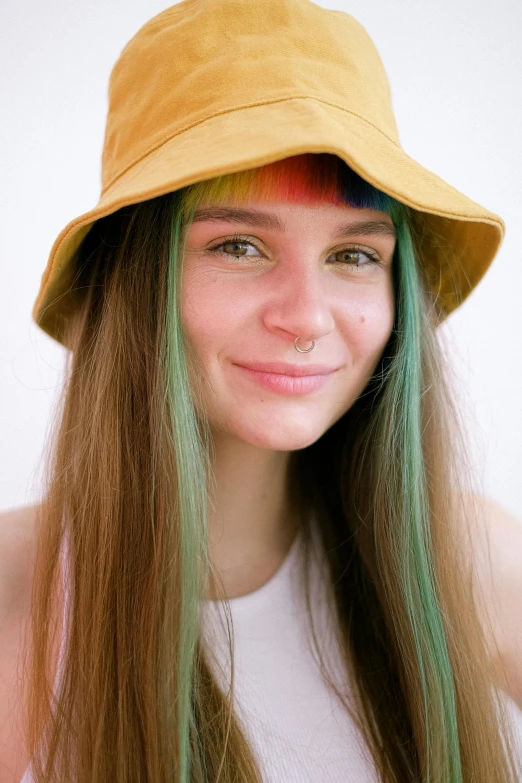 young woman with green hair wearing yellow bucket hat