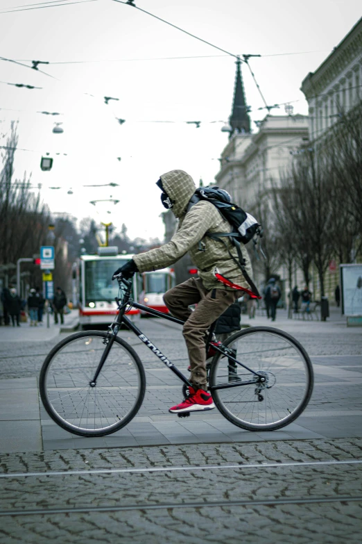 a person wearing winter clothes rides a bicycle