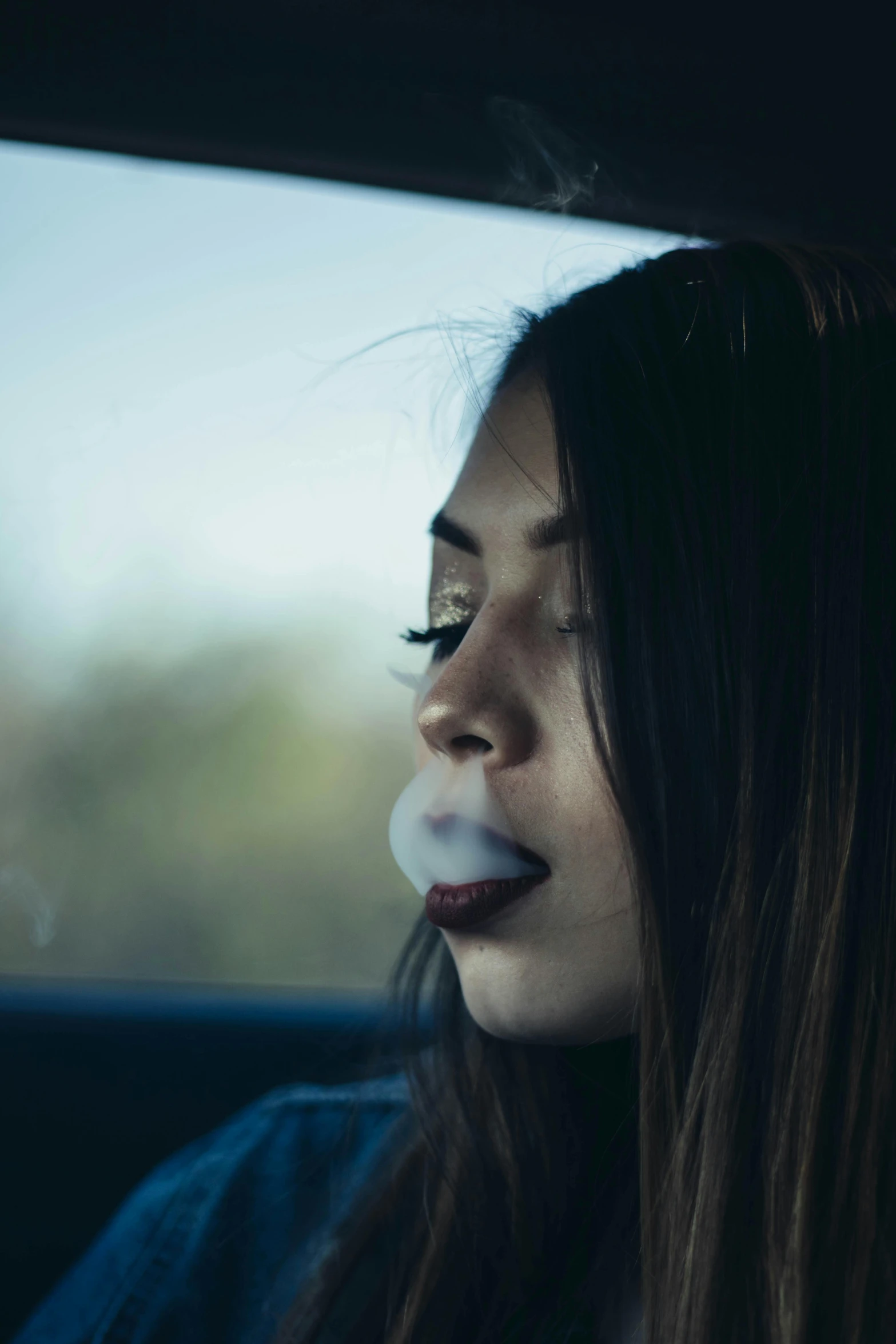 the young woman has her nose pressed to the side of her car