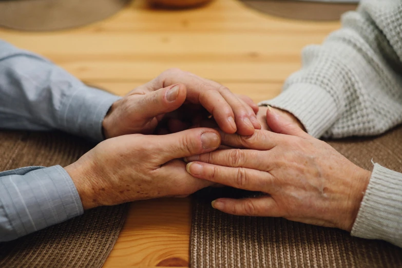 two people are holding hands in their hands