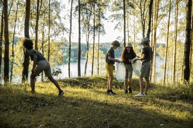 three people standing by the woods while talking