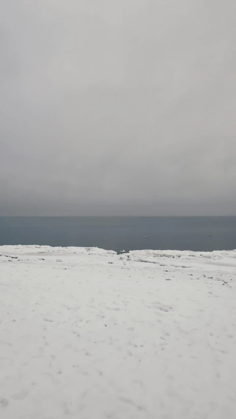 a person riding skis across snow covered ground