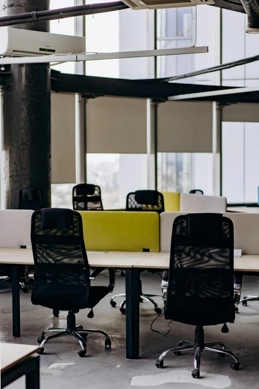 two rows of chairs and an office desk with windows