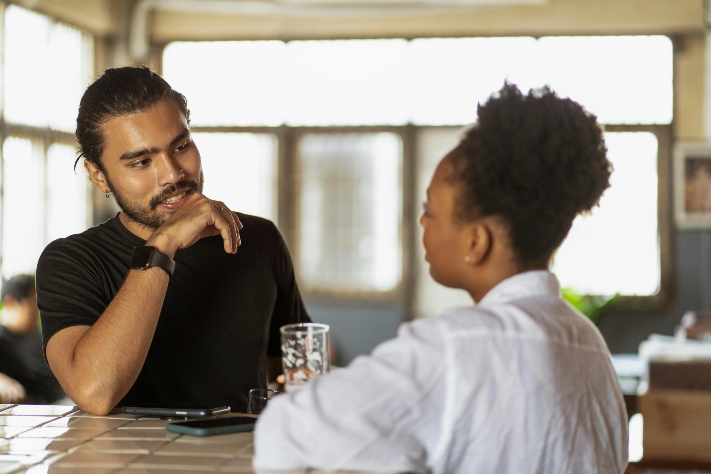 man talking to another person in an office setting