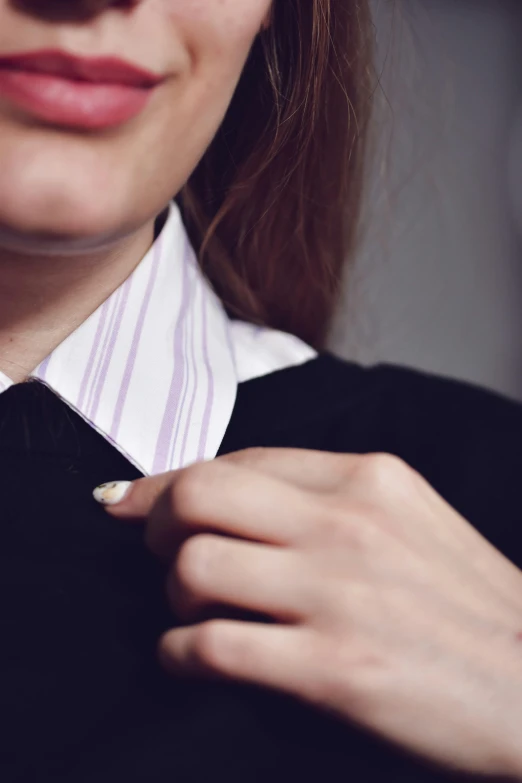 the woman is wearing a collared shirt and tie