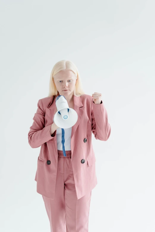 a person in pink and white holding a coffee cup