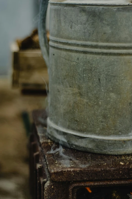 an old steel pan is steaming on top of a burner