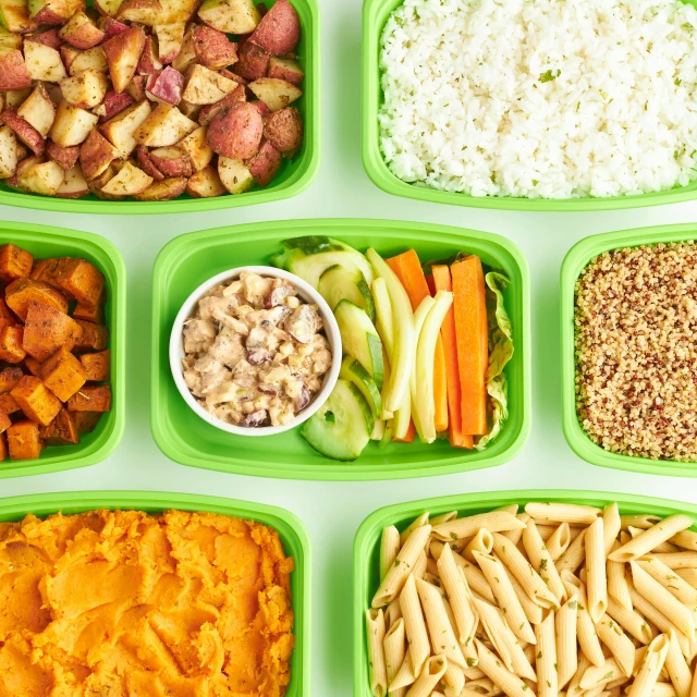 several trays of food are arranged on a table