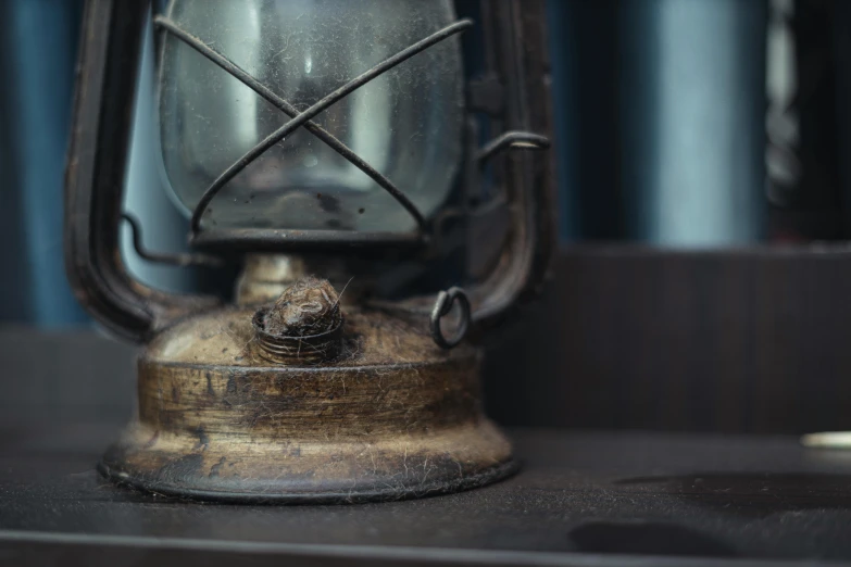 an old lantern on a table with an empty light bulb