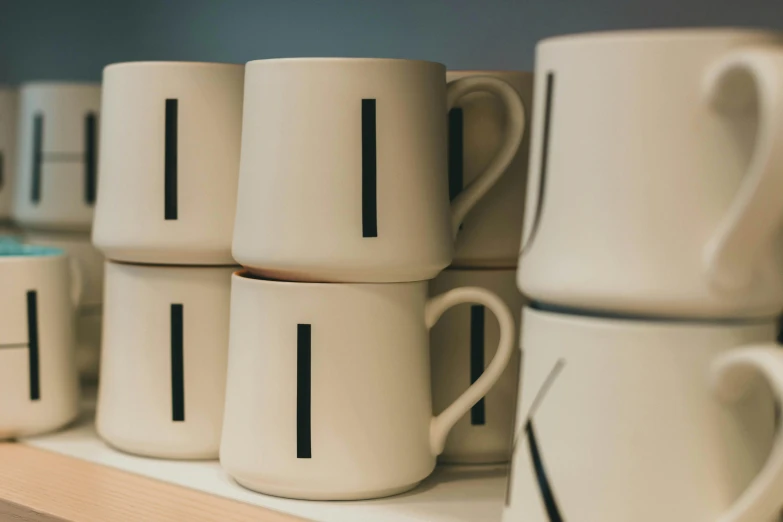 a shelf is filled with coffee cups and vases