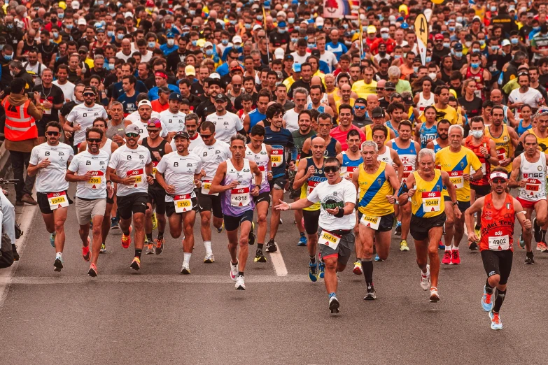 a large group of people running together on a road