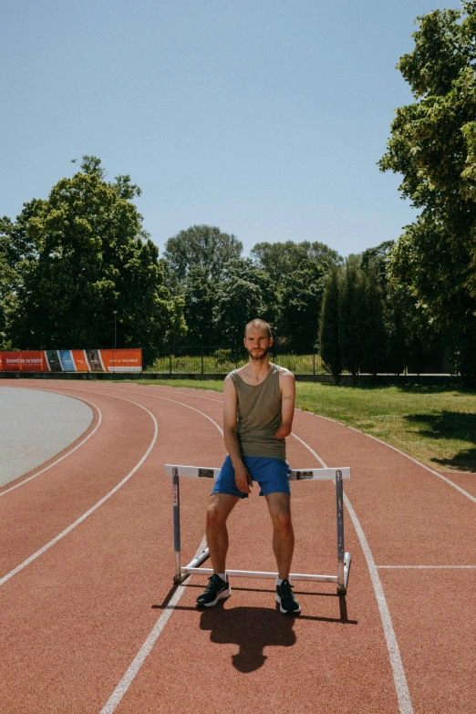 a man sitting on a white bench on a track