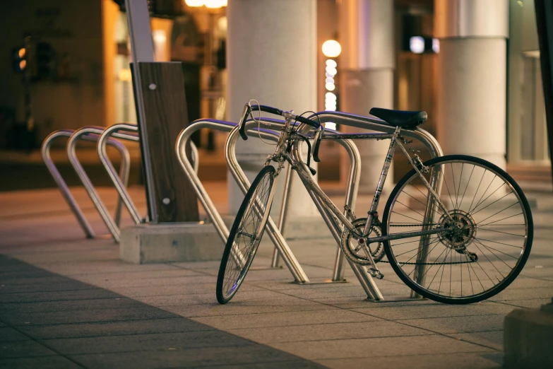 two bicycles locked up on a public sidewalk