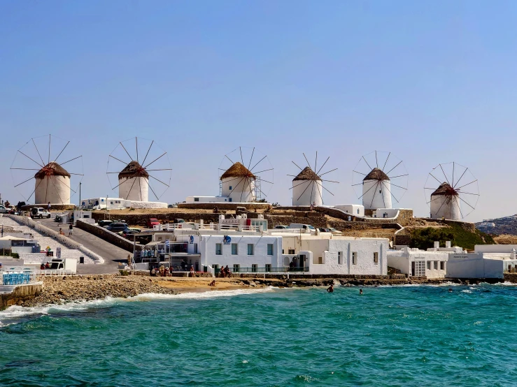 a group of white houses sitting next to the ocean