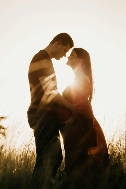 a beautiful couple in their natural pose in the tall grass