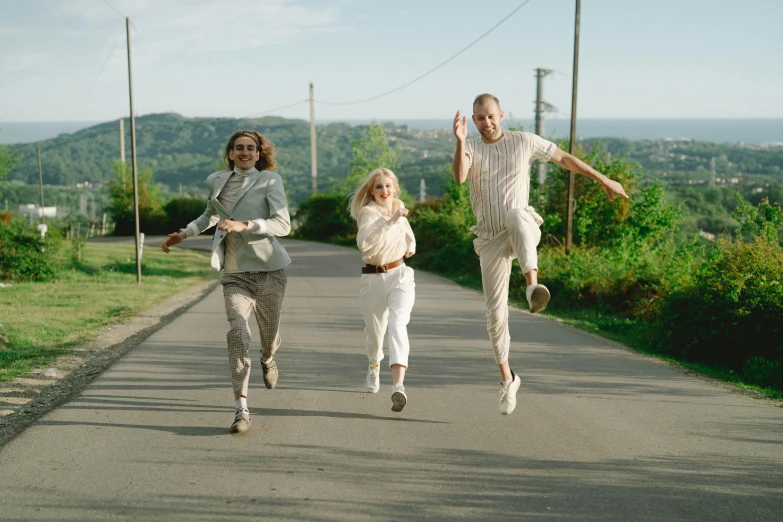 three people running down the road with one another