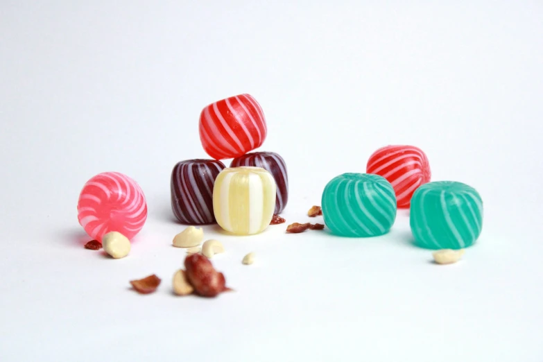 an assortment of candies and peanuts on a white surface