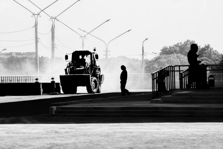 a black and white po shows workers near a tractor