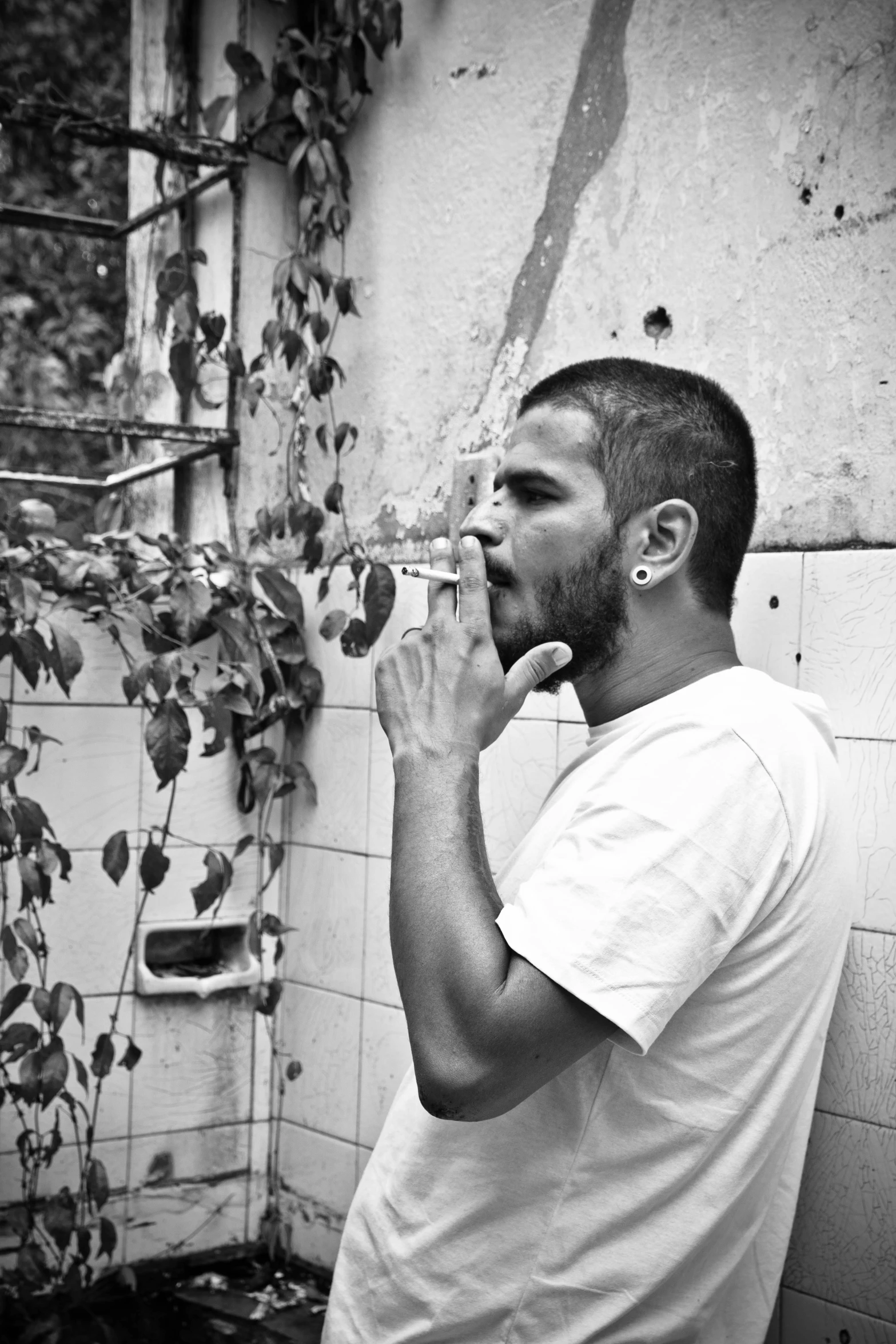 a man in white shirt drinking from a water bottle