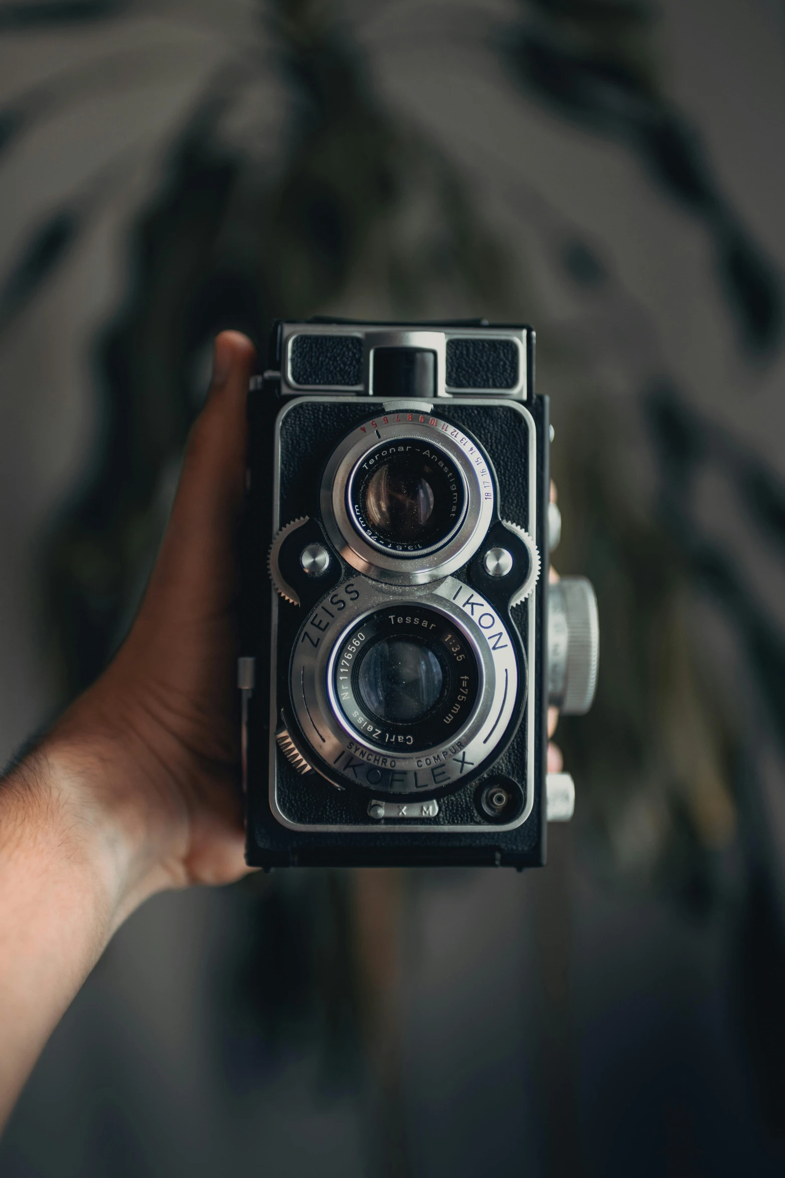 an old - fashioned camera being held by someone's hand