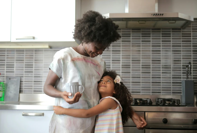 the young mother and daughter are cooking together