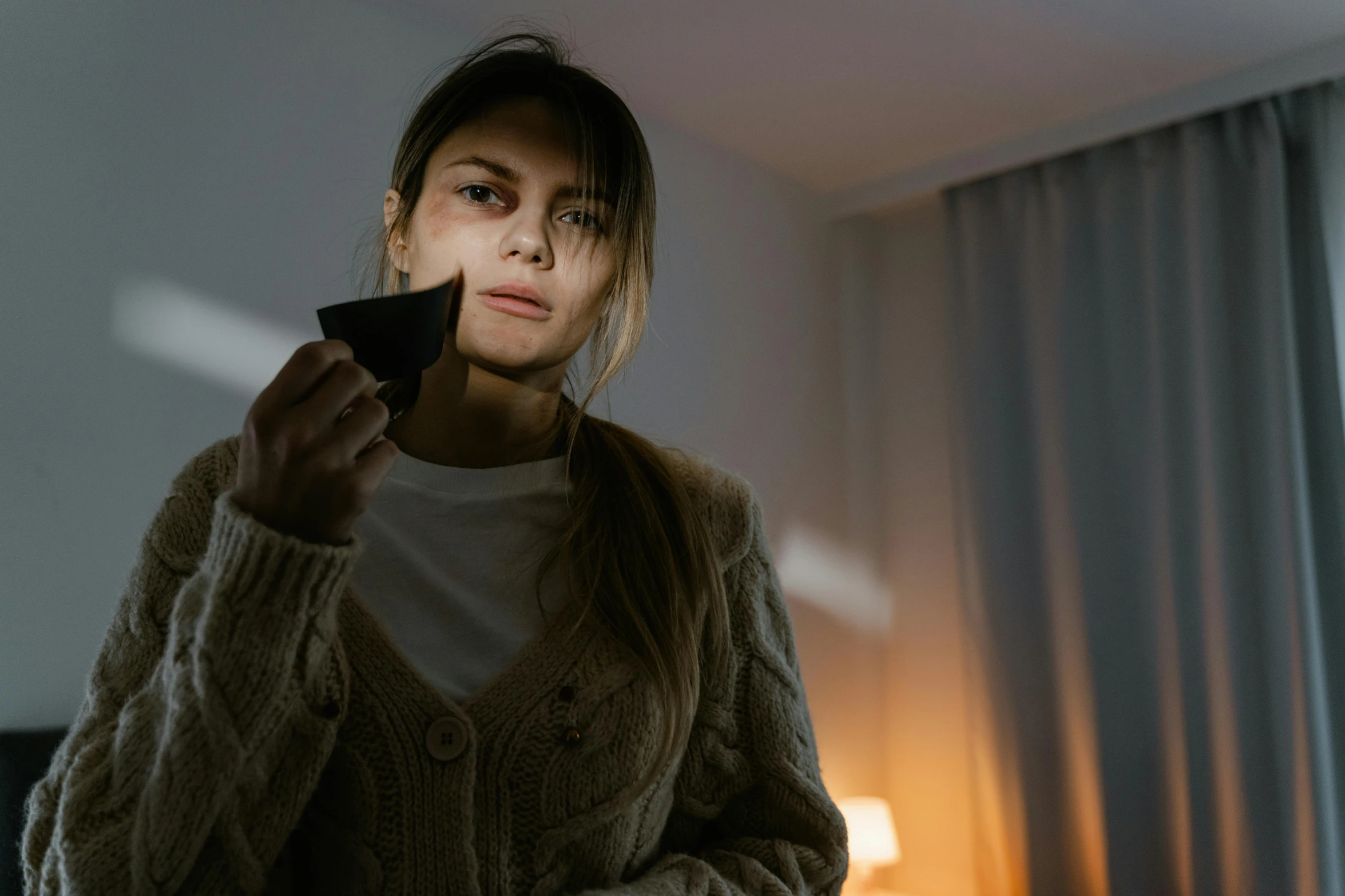 a woman is holding a remote control in her hand