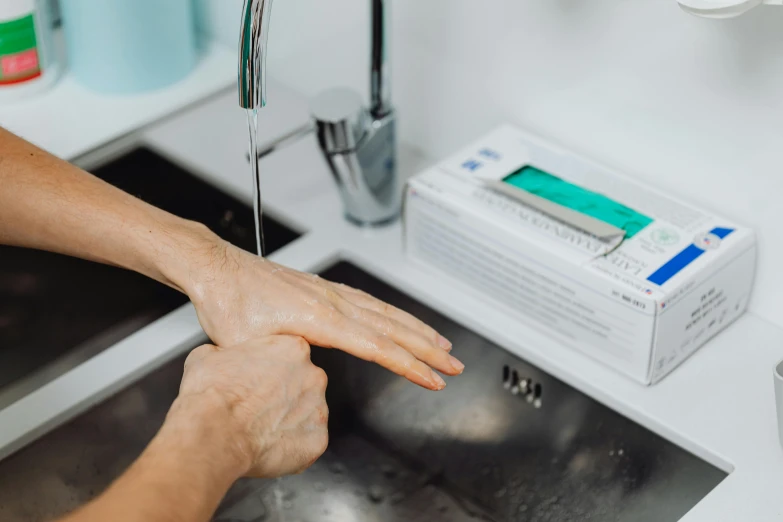 a person is washing their hands with soap