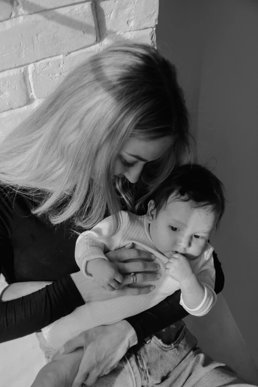 a black and white po of a mom holding a baby