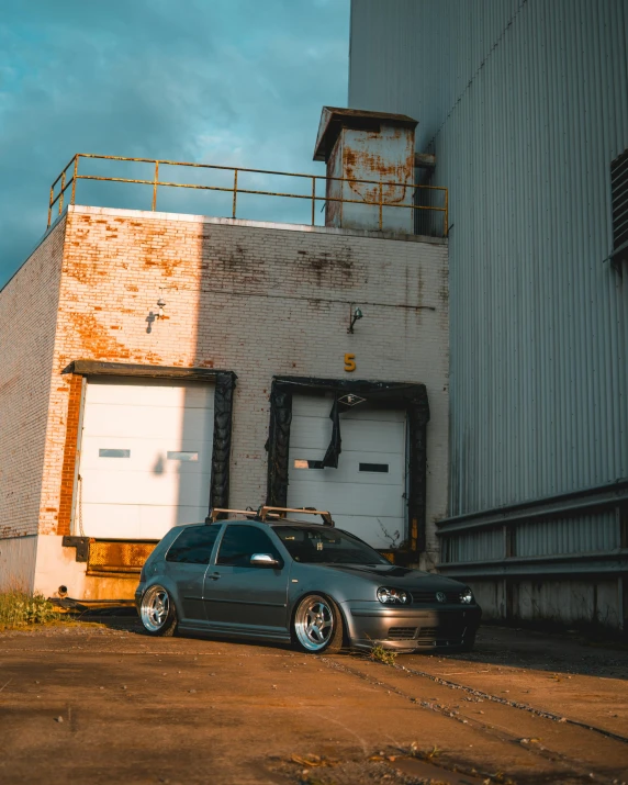 a car parked near a building with an enclosed porch