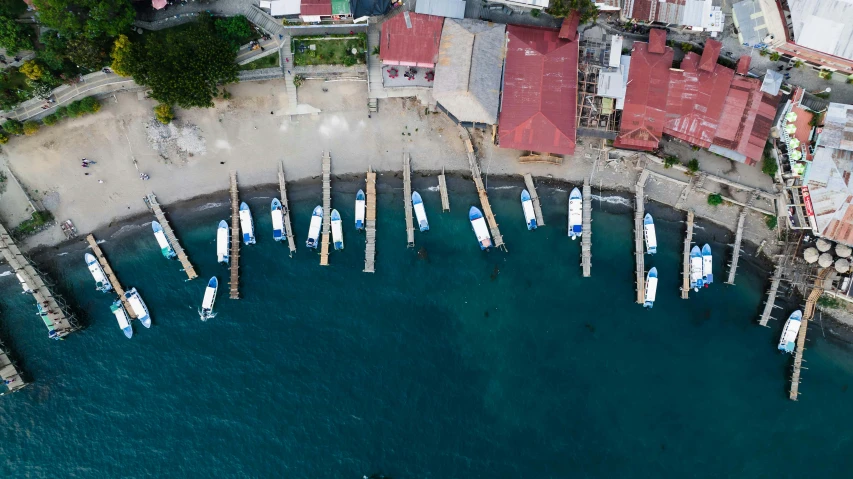 an aerial s shows a group of boats tied in docks