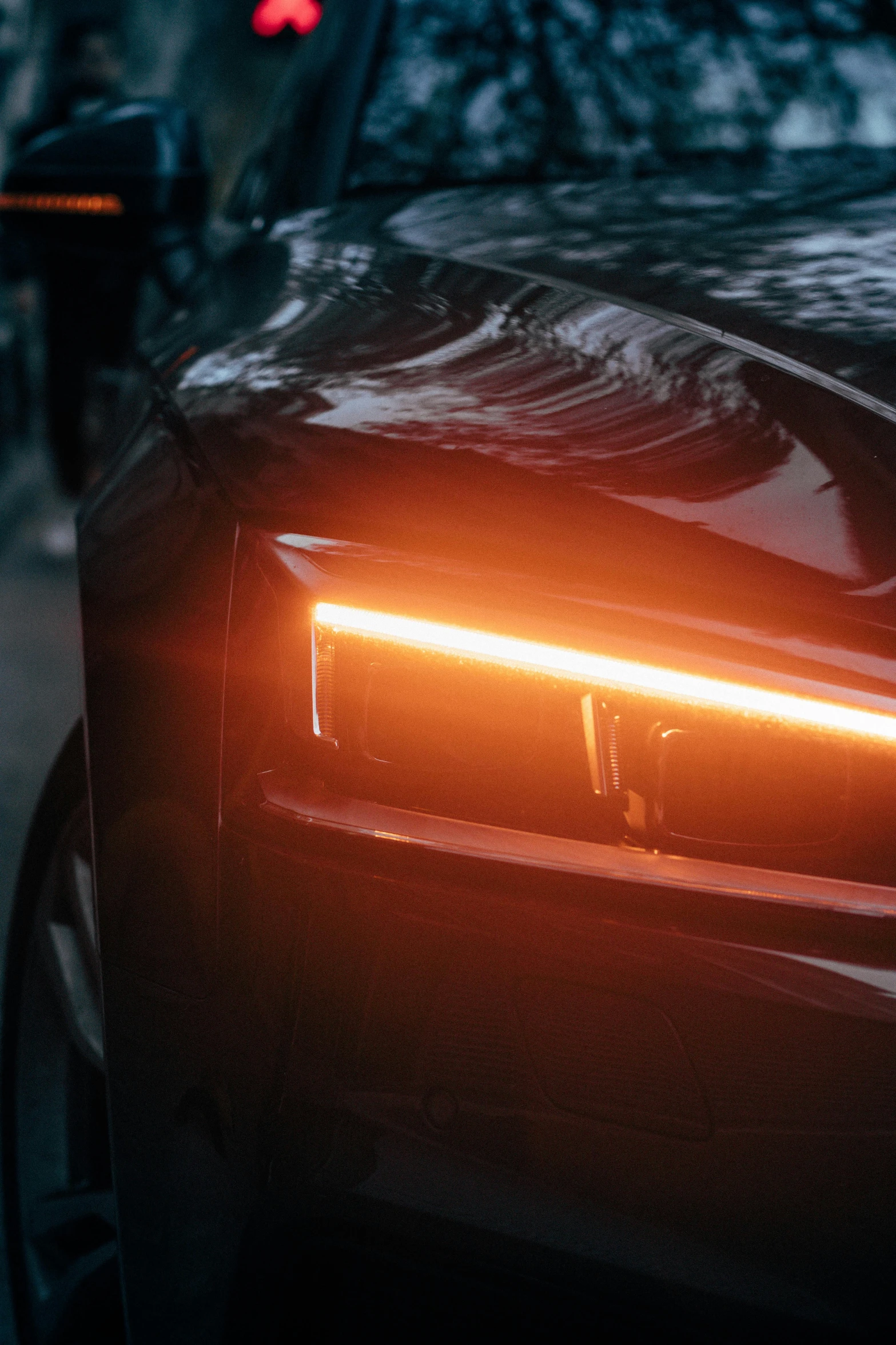 an automobile's tail light is pictured in the background
