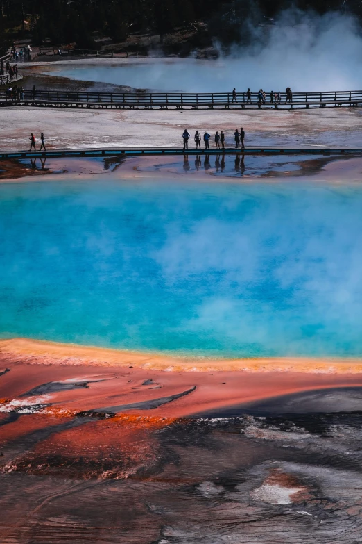 a body of water with a group of people near it