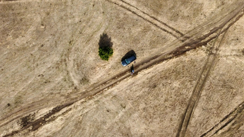 a truck is parked in a field in the sun